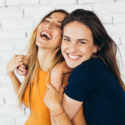 Friends smiling at Smile Arc Dental Group in San Diego, CA